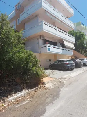a parking lot with cars parked in front of a building at Eolia apartment in Chania with Sea&City View in Chania Town