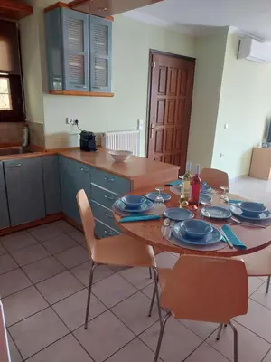 a kitchen with a wooden table with blue dishes on it at Eolia apartment in Chania with Sea&City View in Chania Town