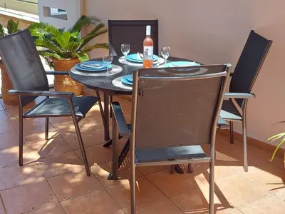 a dining room table with chairs and a bottle of wine at Eolia apartment in Chania with Sea&City View in Chania Town