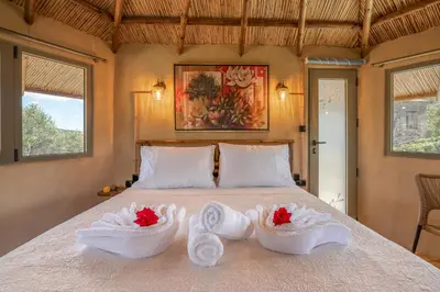 a bedroom with a bed with towels on it at Eco Olive Treehouse in Chania Town