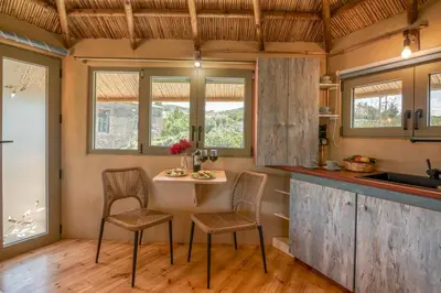 a kitchen with a small table and two chairs at Eco Olive Treehouse in Chania Town