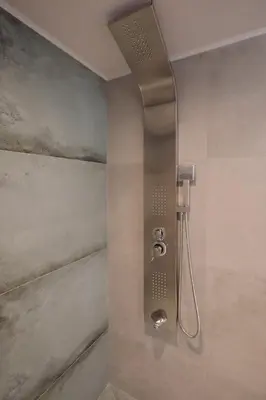 a shower with a shower head in a bathroom at ARCH HOME, luxury property with private parking in Chania Town