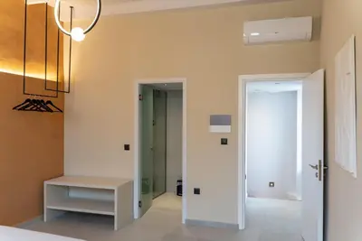 a hallway with a door leading to a room at ARCH HOME, luxury property with private parking in Chania Town