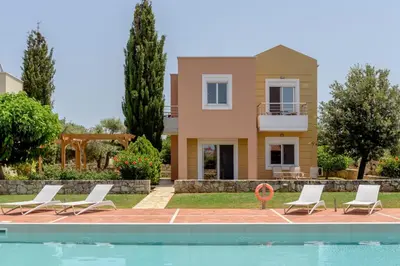 a villa with a swimming pool and a house at Aloni Grove Retreat in Chania Town