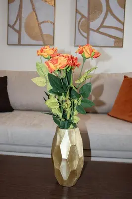 a gold vase with flowers in it on a table at Cherry Central Luxury Suites in Chania Town