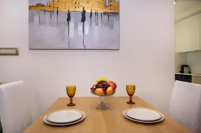 a dining room table with two plates and a bowl of fruit at Cherry Central Luxury Suites in Chania Town