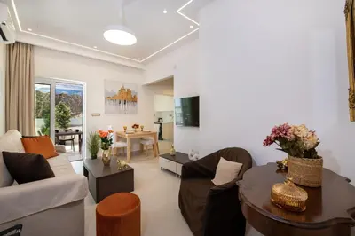a living room with a couch and a table at Cherry Central Luxury Suites in Chania Town