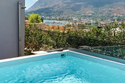 a swimming pool with a view of a mountain at Thearia villa II private heated hydromassage pool in Souda