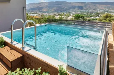 a swimming pool with a view from a house at Thearia villa II private heated hydromassage pool in Souda