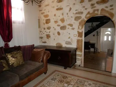 a living room with a couch and a mirror at Christina's Villa with sea view in Daratso