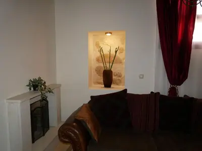 a living room with a couch and a vase with flowers at Christina's Villa with sea view in Daratso