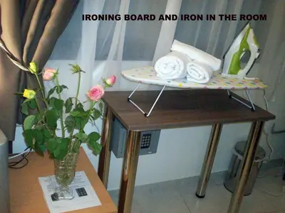 a ironing board and iron in the room on a table at Posto studio 3 Chania Crete 100m from the beach in Daratso