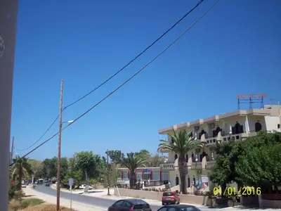 a building on a street with cars parked in front of it at Posto Studio 5 Chania Crete 100 m from the beach in Daratso