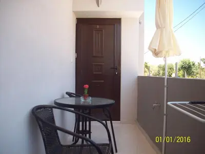a small table in a room with a door at Posto Studio 5 Chania Crete 100 m from the beach in Daratso