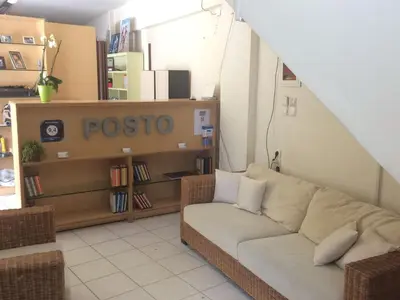 a living room with a couch and a book shelf at Posto Studio 5 Chania Crete 100 m from the beach in Daratso
