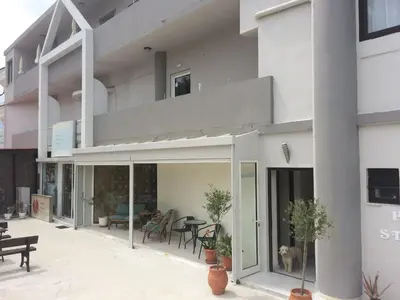 a building with a balcony with a dog on it at Posto Studio 5 Chania Crete 100 m from the beach in Daratso