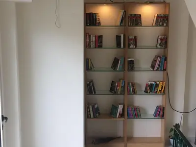 a book shelf filled with books in a room at Posto Studio 5 Chania Crete 100 m from the beach in Daratso