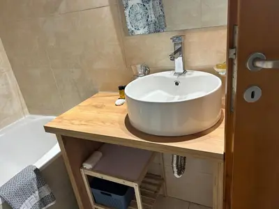 a bathroom with a white sink and a tub at Ferenikis apartment in Chania Town