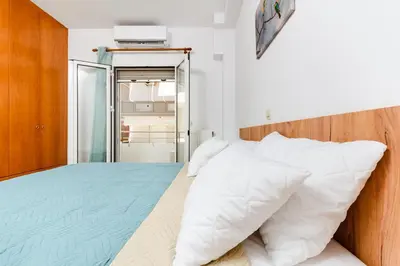 a bedroom with a bed with white pillows at Ferenikis apartment in Chania Town