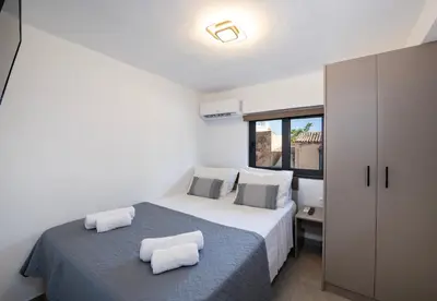 a bedroom with a bed with two pillows on it at Halepa Apartment's in Chania in Chania Town