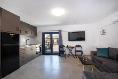 a kitchen and living room with a couch and a table at Halepa Apartment's in Chania in Chania Town