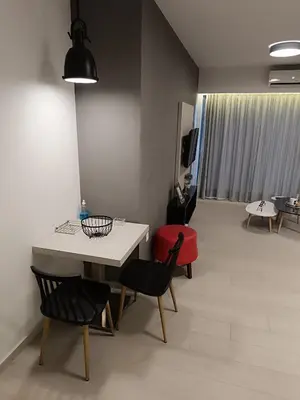 a living room with a white table and chairs at Sandy Suite 1 in Agia Marina Nea Kydonias
