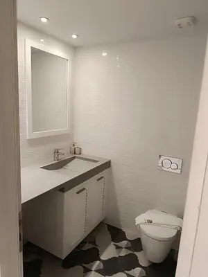 a bathroom with a toilet and a sink and a mirror at Sandy Suite 1 in Agia Marina Nea Kydonias