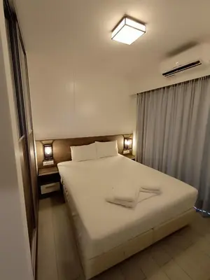 a bedroom with a large white bed and a window at Sandy Suite 2 in Agia Marina Nea Kydonias