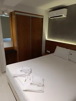 a bedroom with a bed with white towels on it at Sandy Suite 3 in Agia Marina Nea Kydonias