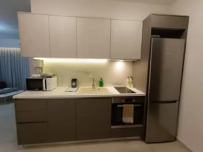 a kitchen with a sink and a refrigerator at Sandy Suite 3 in Agia Marina Nea Kydonias