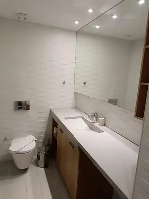 a bathroom with a toilet and a sink and a mirror at Sandy Suite 3 in Agia Marina Nea Kydonias