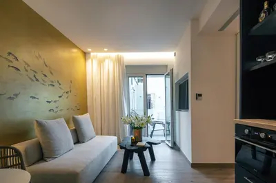 a living room with a couch and a table at Sea Path I Chania City Center luxury Suites in Chania Town