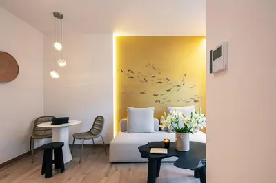 a hotel room with a bed and a table at Sea Path I Chania City Center luxury Suites in Chania Town