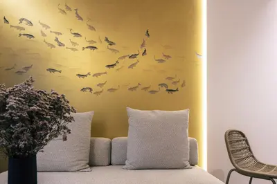 a room with a couch with bats on the wall at Sea Path II Chania city Center luxury Suites in Chania Town