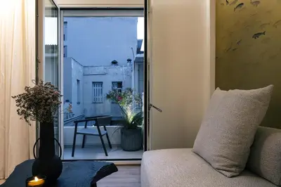 a living room with a couch and a sliding glass door at Sea Path II Chania city Center luxury Suites in Chania Town