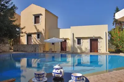 a swimming pool in front of a house at Heliopetra studios, small village near beaches in Douliana