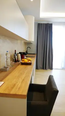 a kitchen with a counter with a bowl of bananas on it at Amour Relax Hotel in Almirida