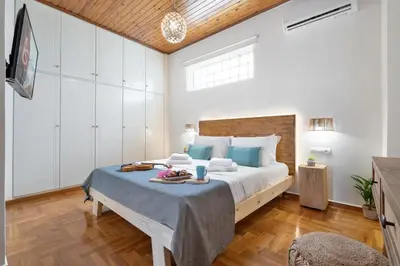 a bedroom with a large bed with blue pillows at Maestro House in Chania Town
