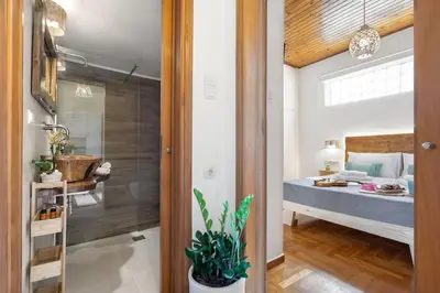 a room with a bedroom with a bed and a bathroom at Maestro House in Chania Town
