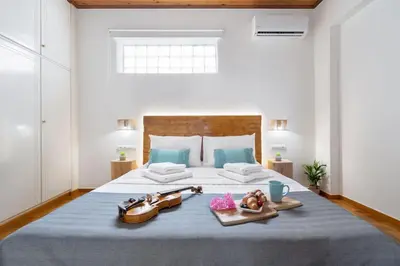a bedroom with a bed with two shoes and a tray of food at Maestro House in Chania Town