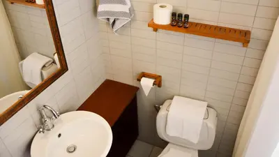 a small bathroom with a toilet and a sink at Proimos Maisonnettes in Plataniás