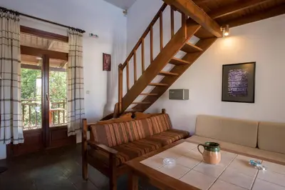 a living room with a couch and a table at Proimos Maisonnettes in Plataniás