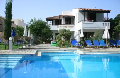a villa with a swimming pool in front of a house at Proimos Maisonnettes in Plataniás
