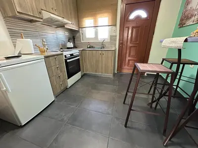 a kitchen with a white refrigerator and a stove at Marias Apartment in Chania Town