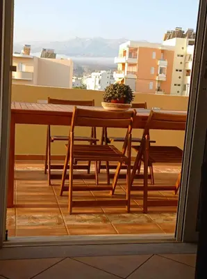 a table and chairs on a balcony with a view at Sonema Seaside Apt in Chania Town