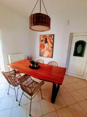 a wooden dining room table with chairs in a room at Sonema Seaside Apt in Chania Town