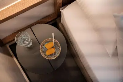 a bowl of fruit on a table next to a bed at Monk Residence 27 - next to old Venetian Harbor in Chania Town