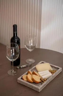 a table with a bottle of wine and two wine glasses at Monk Residence 27 - next to old Venetian Harbor in Chania Town