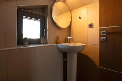 a bathroom with a sink and a window at Filitsa's Luxury House in Chania Town
