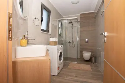 a bathroom with a sink and a washing machine at Filitsa's Luxury House in Chania Town